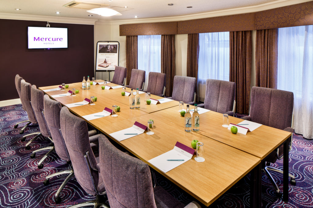 mercure-chester-abbots-well-hotel-the-dee-meeting-01-lr-301117 Tables and chairs set for a meeting or conference in The Ambassador Room at mercure gloucester bowden hall hotel