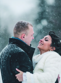 bride and groom in a winter frost with a snowflow