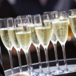 Tray of Champagne drinks being served on a sunny day outdoors