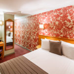Compact double room at Mercure Chester Abbots Well Hotel, red floral wallpaper, desk, tv, mirror