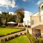 Exterior shot of the gardens at Mercure Chester Abbots Well Hotel, patio seating area