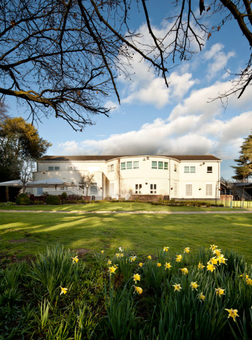 Exterior shot of the gardens at Mercure Chester Abbots Well Hotel, daffodils in the foreground