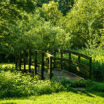 The gardens at Mercure York Fairfield Manor Hotel, wooden bridge over stream