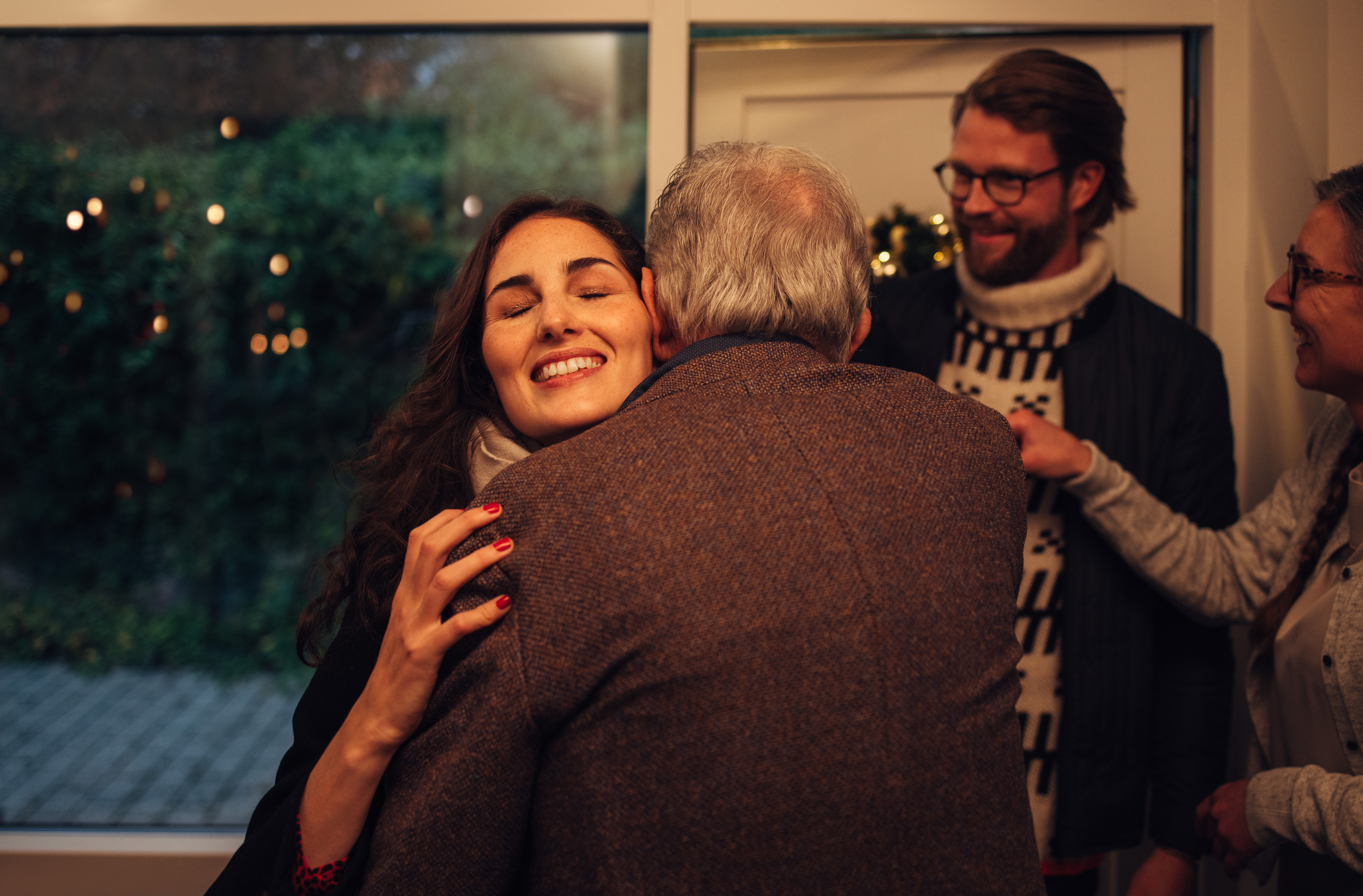 Family,Coming,Over,For,Christmas,Dinner,At,The,Grandparents,Home. couple visiting grandparents for Christmas